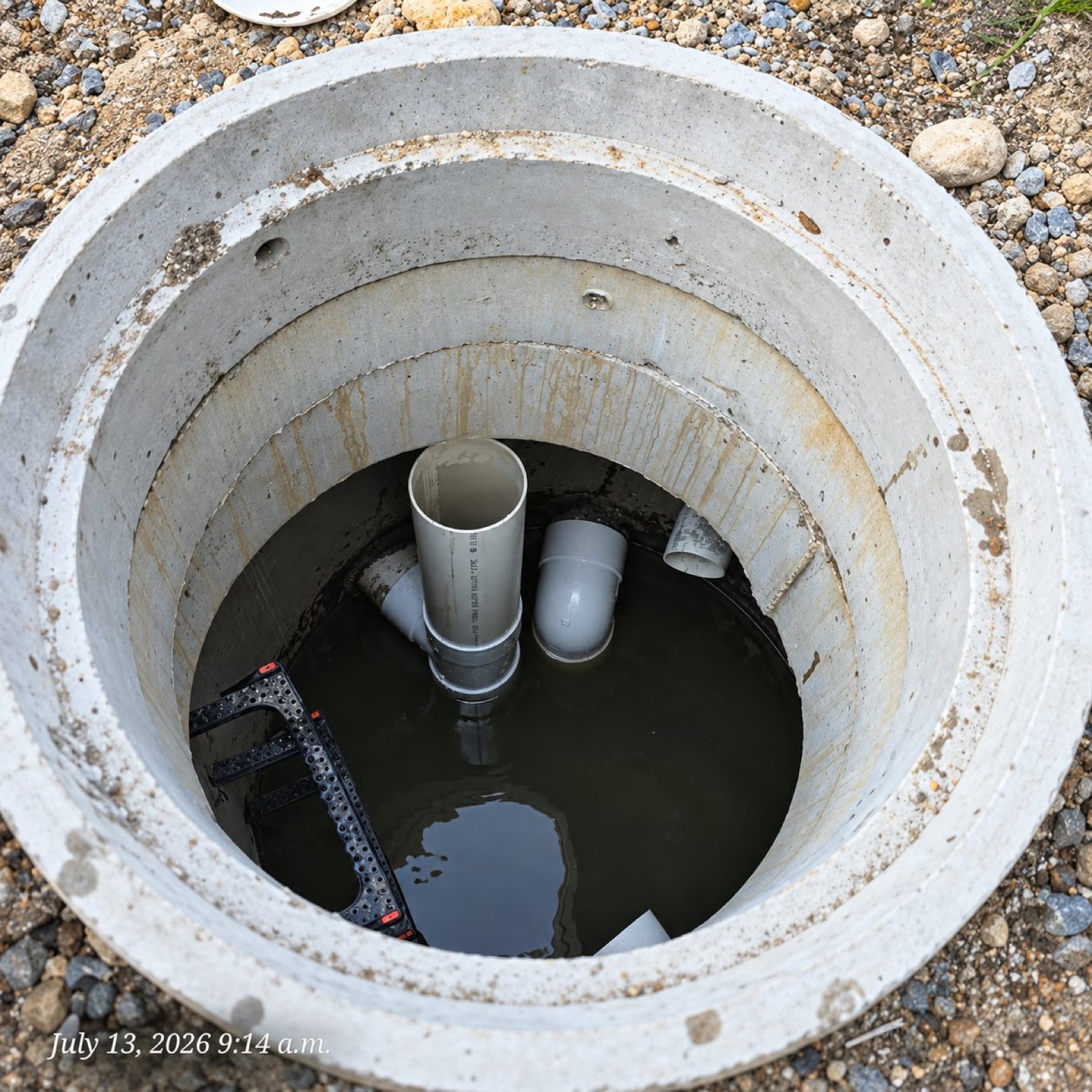 Precast concrete storm manhole with PVC pipe connections